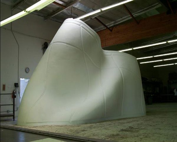 A large white sculpture in an industrial setting.