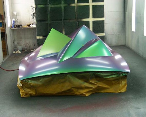 A green and purple object sitting on top of a table.