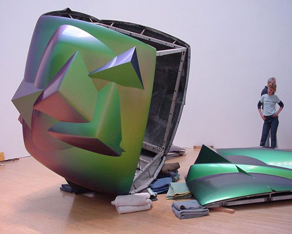 A green computer case sitting on top of a wooden table.